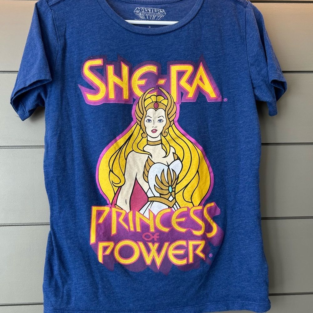 You’re the Princess of Power in this blue She-Ra T-shirt. Size YM